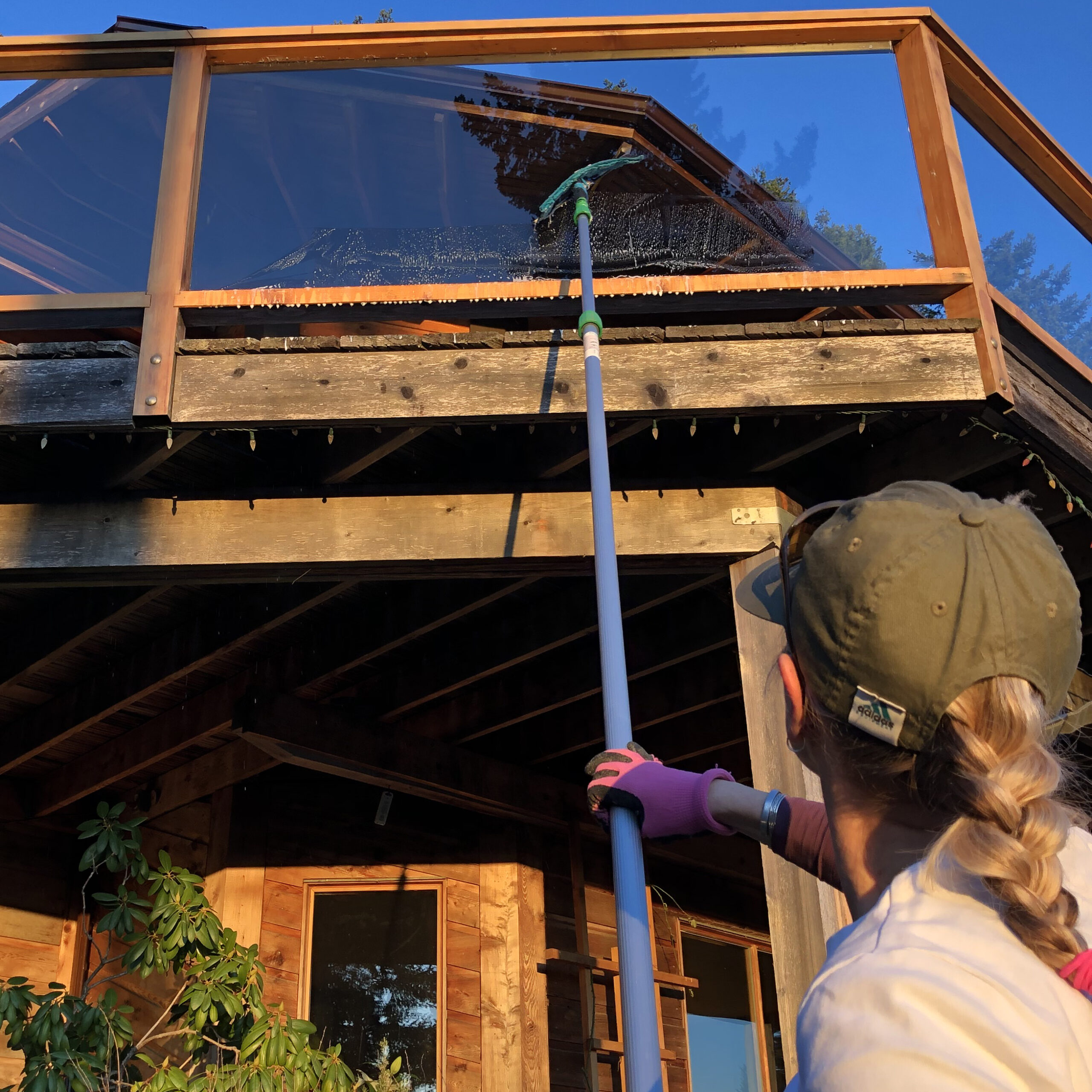 Rhonda cleaning patio rail glass.